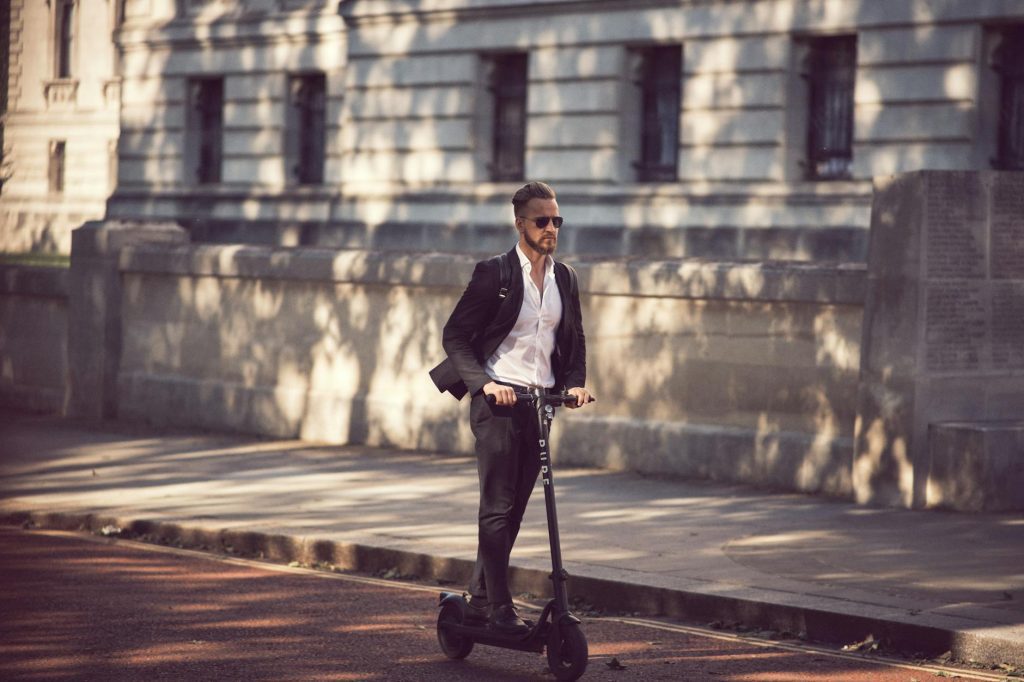 photo of a man on an electric scooter