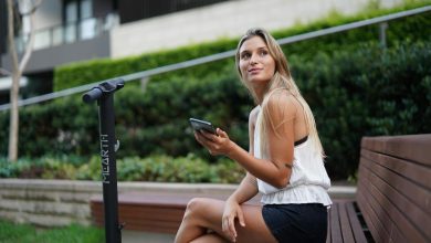 woman in white tank top and black shorts sitting on brown wooden bench