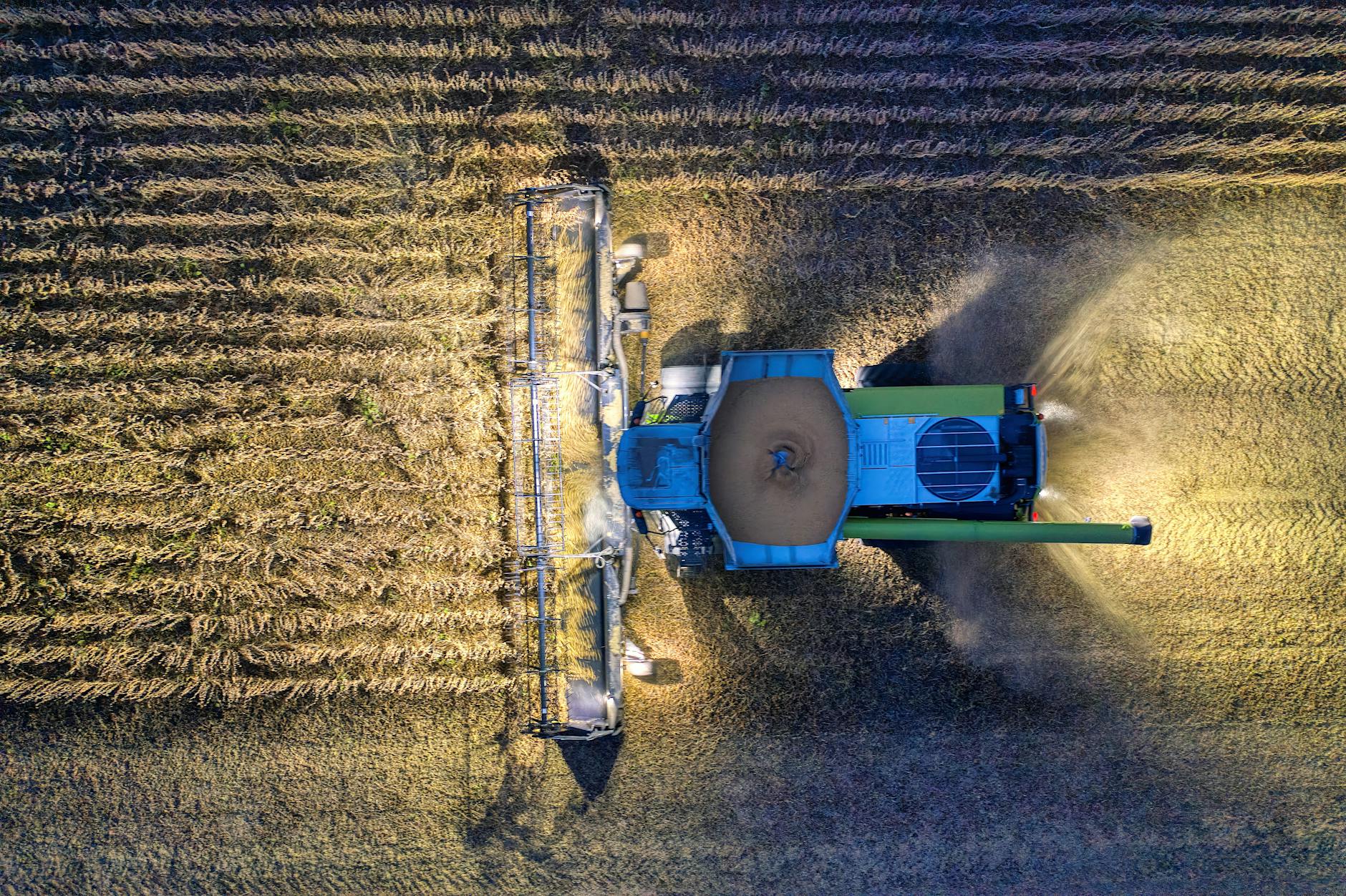 farm tractor harvesting on field